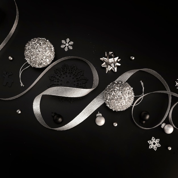 Free photo flat lay of silver christmas ornaments with ribbon