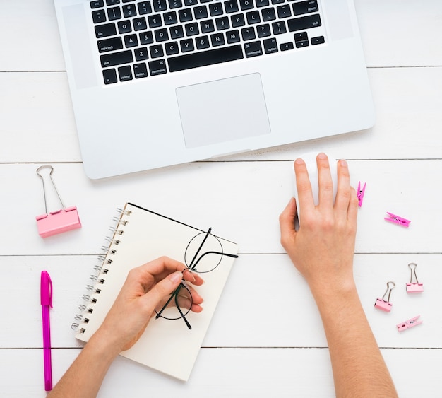 Flat lay of simple office desk with pink supplies