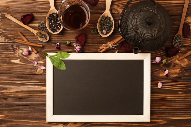 Free photo flat lay slate template with tea concept