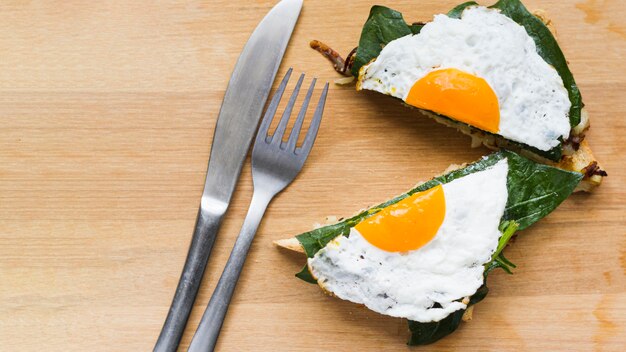 Flat lay sliced fried egg on waffle