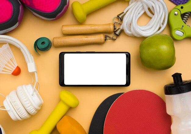 Flat lay of smartphone with sport essentials and headphones