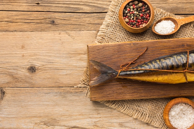 Flat lay smoked fish on wooden background