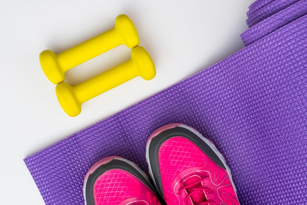 Free photo flat lay of sneakers with weights