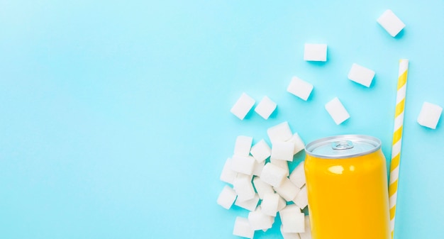 Free photo flat lay of soft drink can with sugar cubes and straw