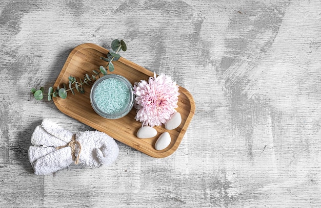 Flat lay spa composition with body products on textured concrete background