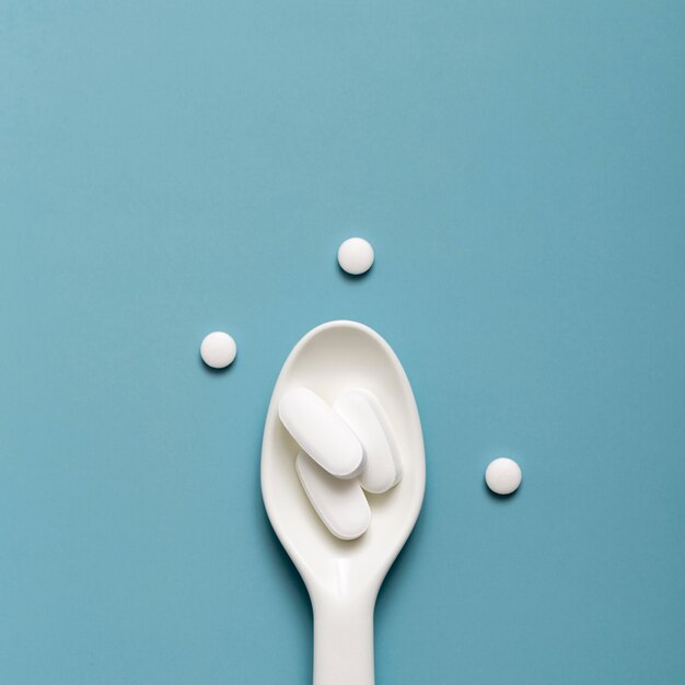 Flat lay of spoon with pills in it