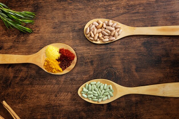 Flat lay spoons with spices and beans