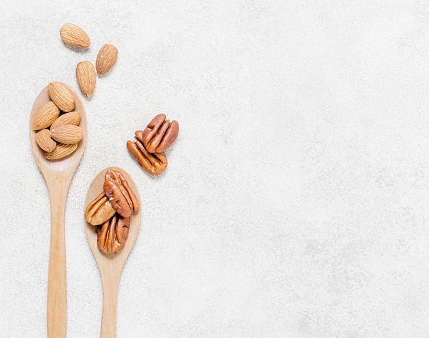 Flat lay of spoons with walnuts and almonds