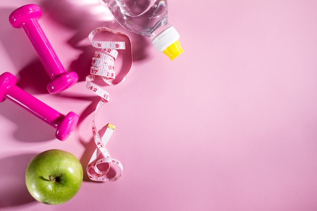 Flat Lay Sport Concept Healthy Life Equipment on Bright Pink Background. Closeup with Copy Space. 