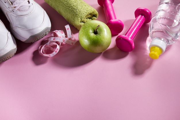 Flat Lay Sport Concept Healthy Life Equipment on Bright Pink Background. Closeup with Copy Space. 