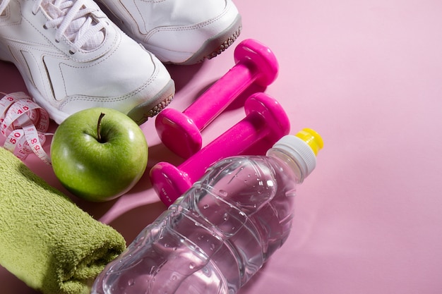 Flat Lay Sport Concept Healthy Life Equipment on Bright Pink Background. Closeup with Copy Space. 