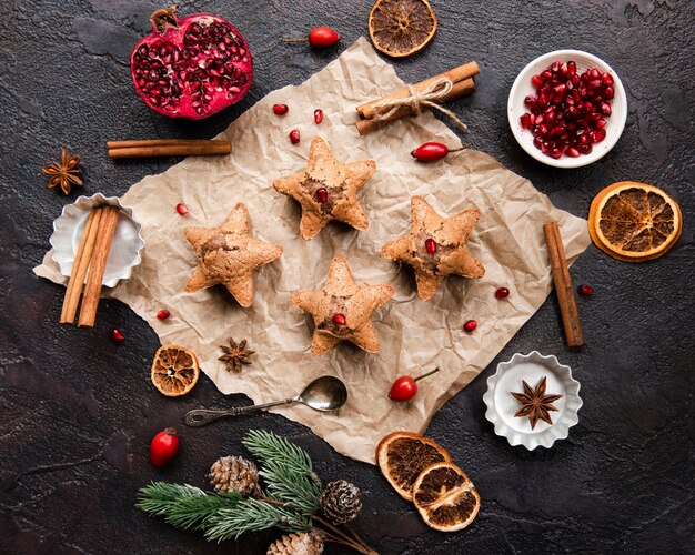 Flat lay of star-shaped cookies with pomegranate and cinnamon