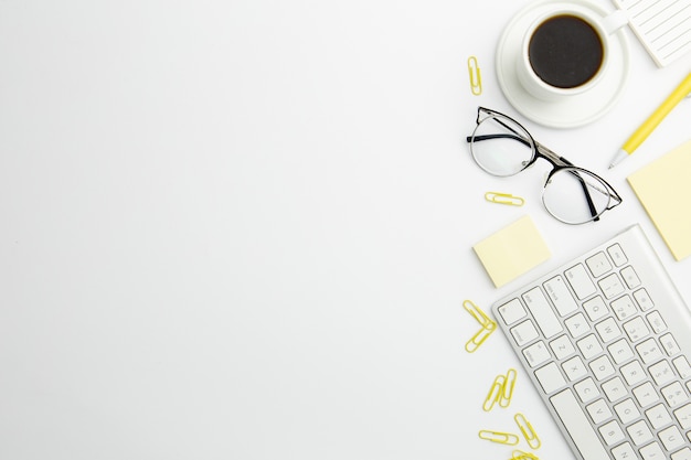 Flat lay stationary arrangement on desk with copy space and coffee