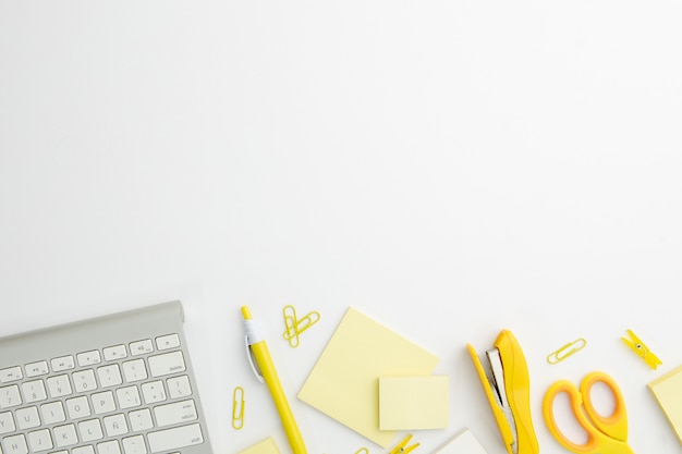 Flat lay stationary arrangement on desk with yellow supplies