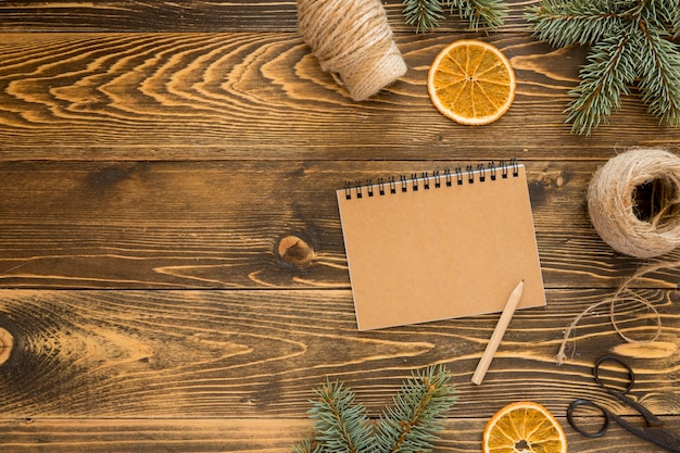 Flat lay stationery empty notepad and slices of lemon