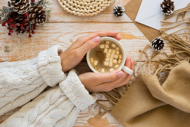 Flat lay stationery envelope and woman with tea