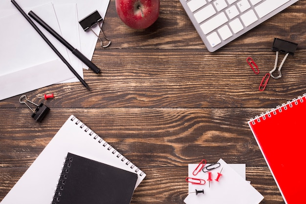 Flat lay of stationery on wooden desk