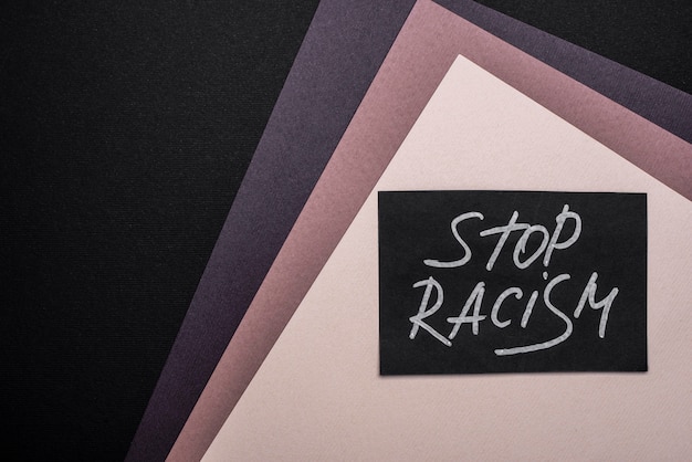 Free photo flat lay of stop racism card on multicolored paper with copy space