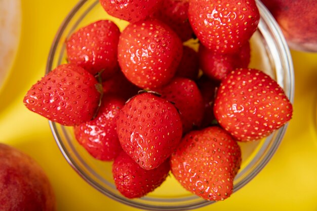 Flat lay strawberries in a bowl on plain background