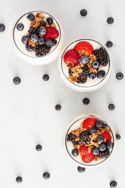 Flat lay strawberry and blueberry yogurt