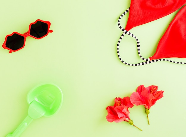 Flat lay of summer accessories and flowers