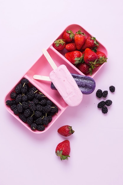 Flat lay summer ice cream with strawberries and blackberries