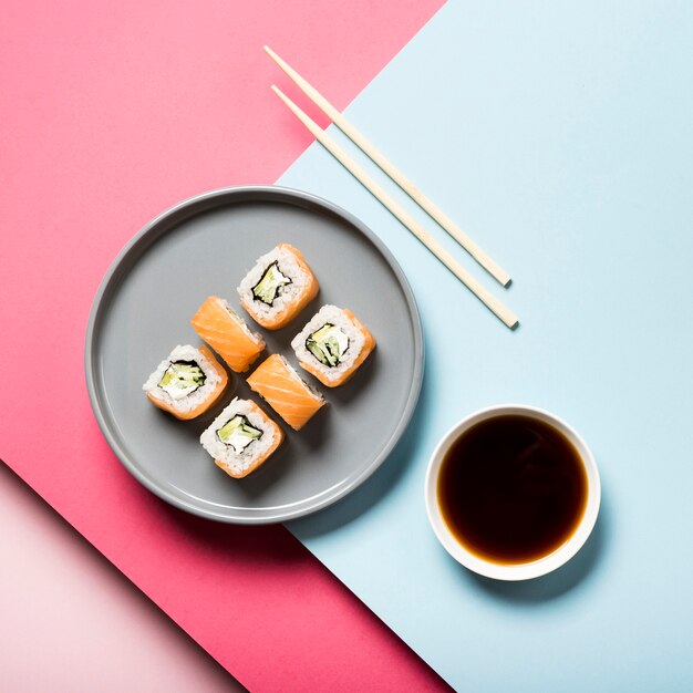 Flat lay sushi plate with chopsticks and soy sauce