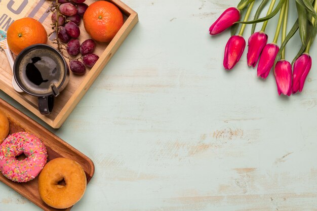 Flat lay of sweet breakfast and tulips