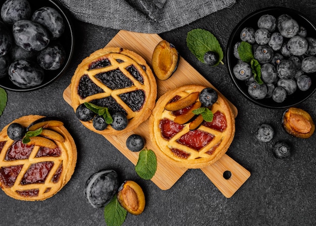Flat lay of sweet pies with fruits