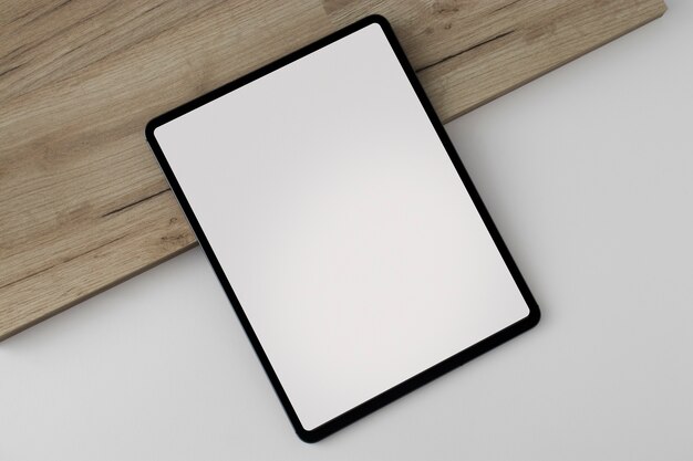 Flat lay tablet on wooden board minimal display