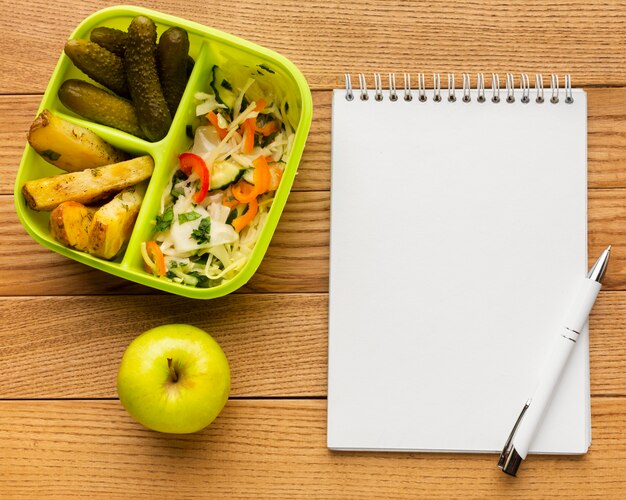 Flat lay tasty meal composition with empty notebook