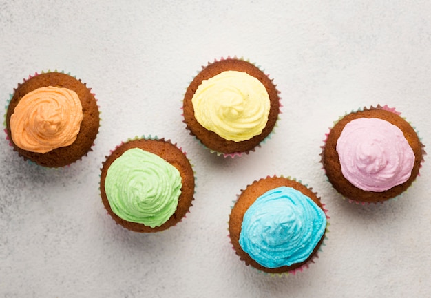 Flat lay tasty muffin with blue glaze