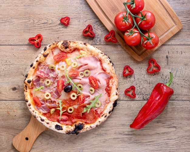 Flat lay tasty pizza on wooden background