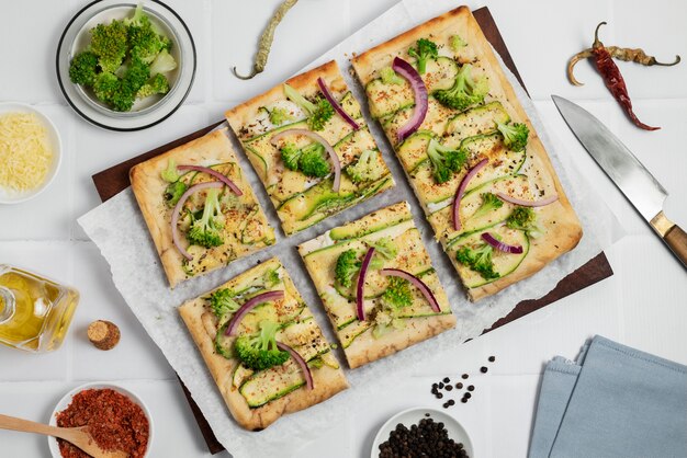 Flat lay tasty pizza on wooden board