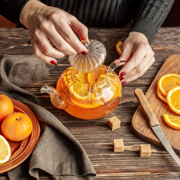 Flat lay of tea concept with orange slice