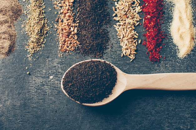 Flat lay tea in spoons with dried herbs