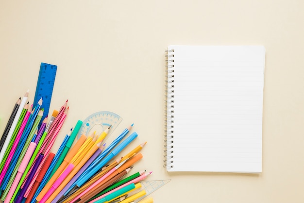 Flat lay of textbook and pencils