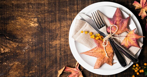Flat lay of thanksgiving dinner table arrangement with cutlery and copy space
