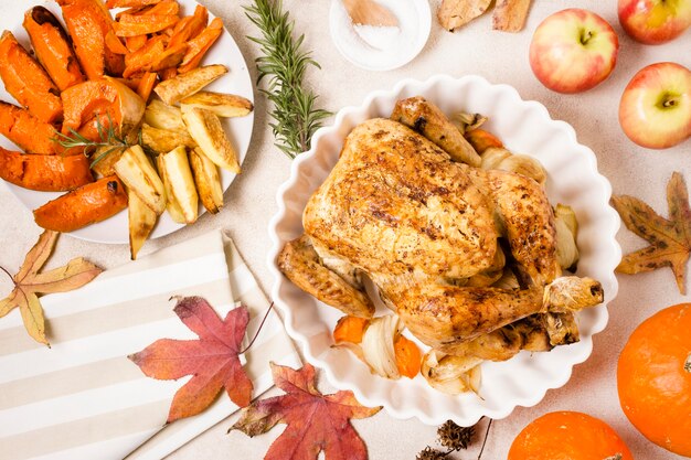 Flat lay of thanksgiving roasted chicken on plate with other dishes