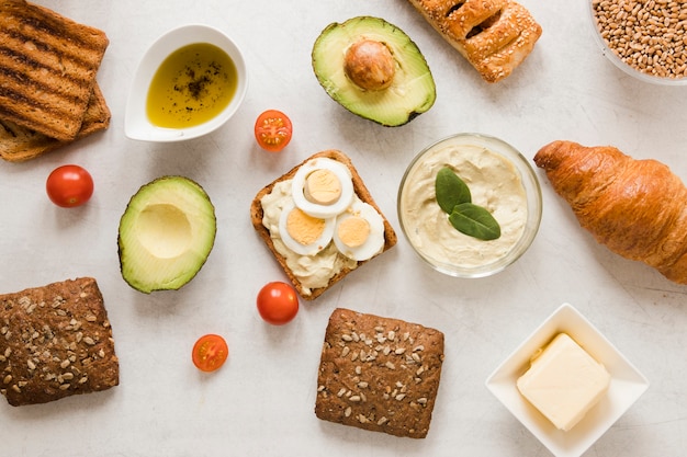 Flat lay toast with hummus eggs and avocado