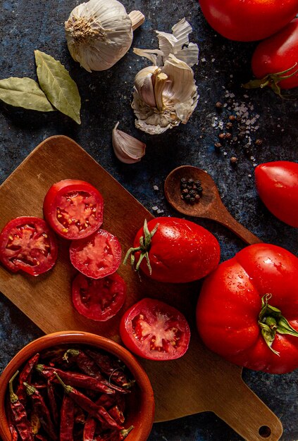 Flat lay of tomatoes with garlic and bay leaves