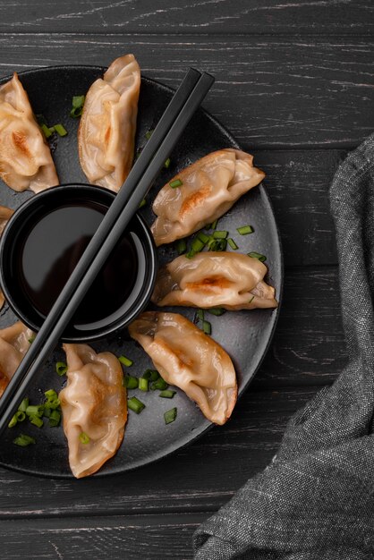 Flat lay of traditional asian dish with chopsticks and dumplings