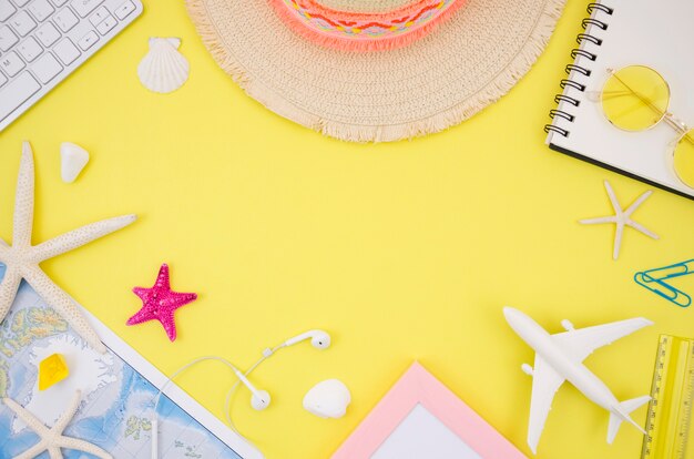 flat lay of travel accessories on yellow background
