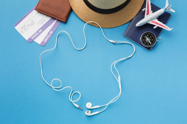 Free photo flat lay of travel essentials with headphones and compass