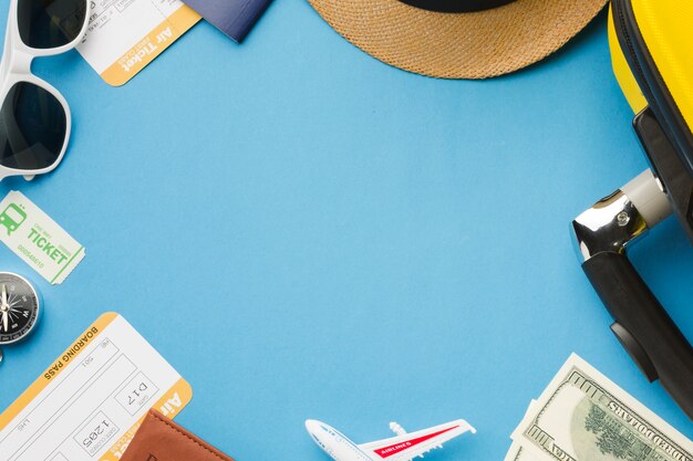 Flat lay of travel essentials with sunglasses and money