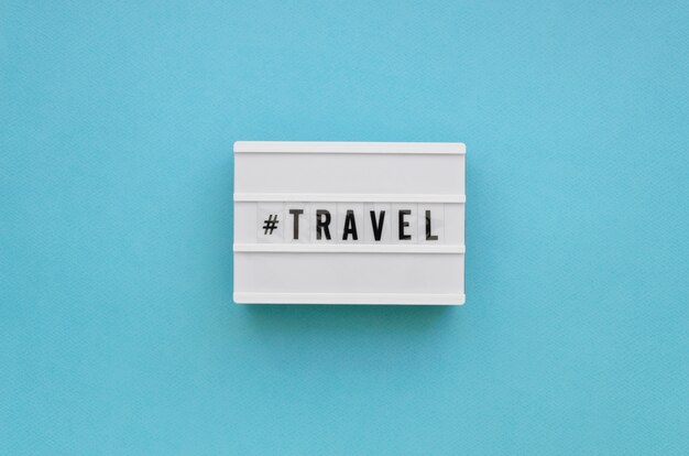 Flat lay travel message with blue background