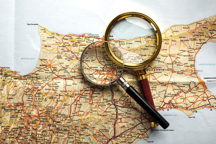 Free Photo flat lay travel set with magnifying glass on map