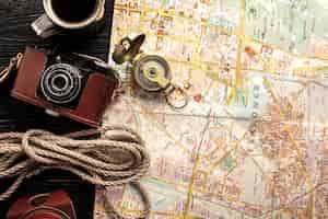 Free photo flat lay travel set with map and camera