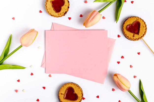 Flat lay of tulips and cookies with papers for valentines day