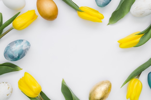 Flat lay of tulips and easter eggs frame